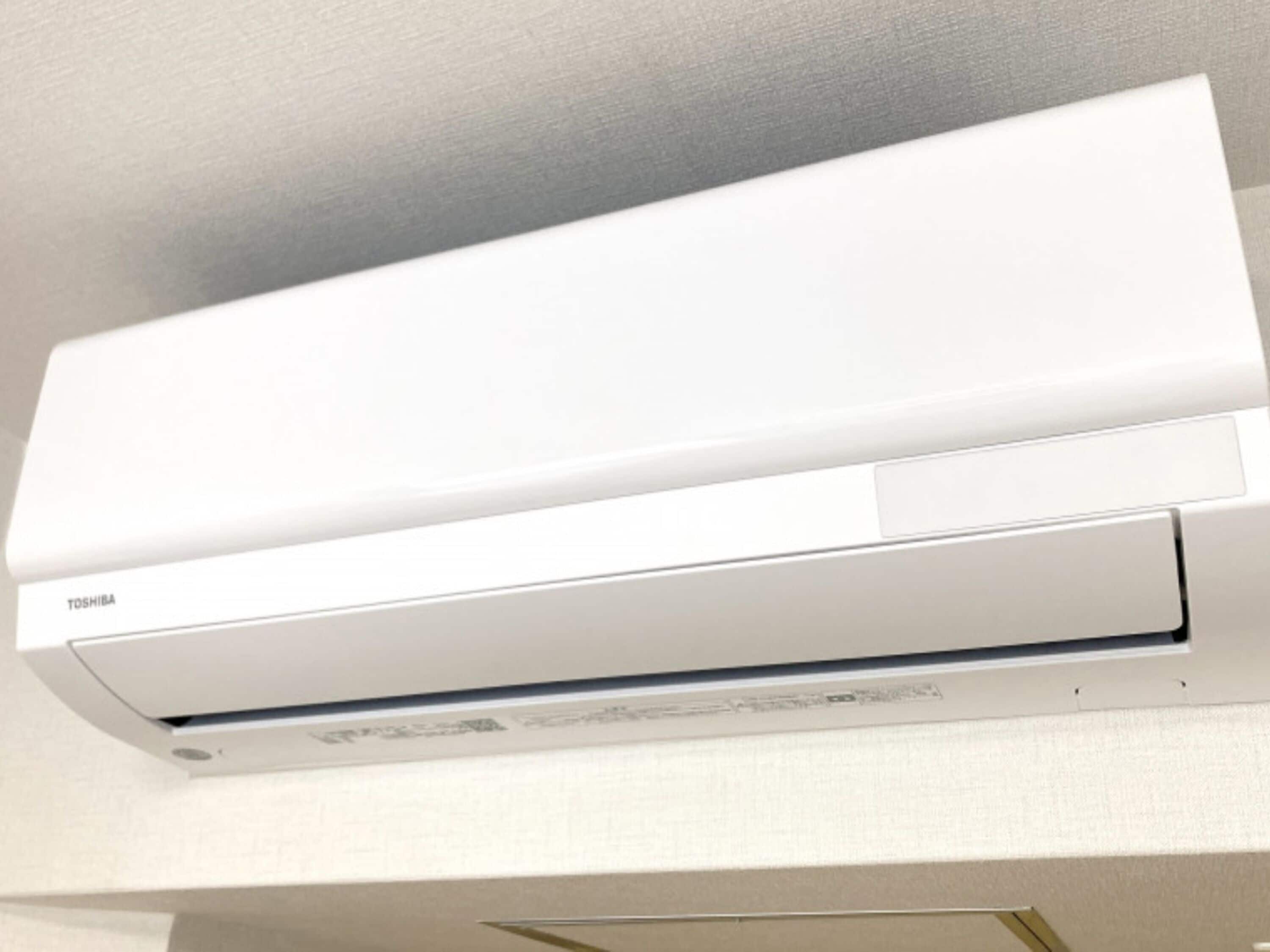 A white air conditioning unit mounted on a wall.