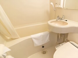 Combined shower/tub, free toiletries, hair dryer, slippers