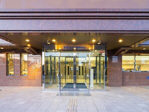A modern building entrance with a glass door and a ramp leading inside. - Toyoko Inn Gotemba Ekimae (Gotemba)