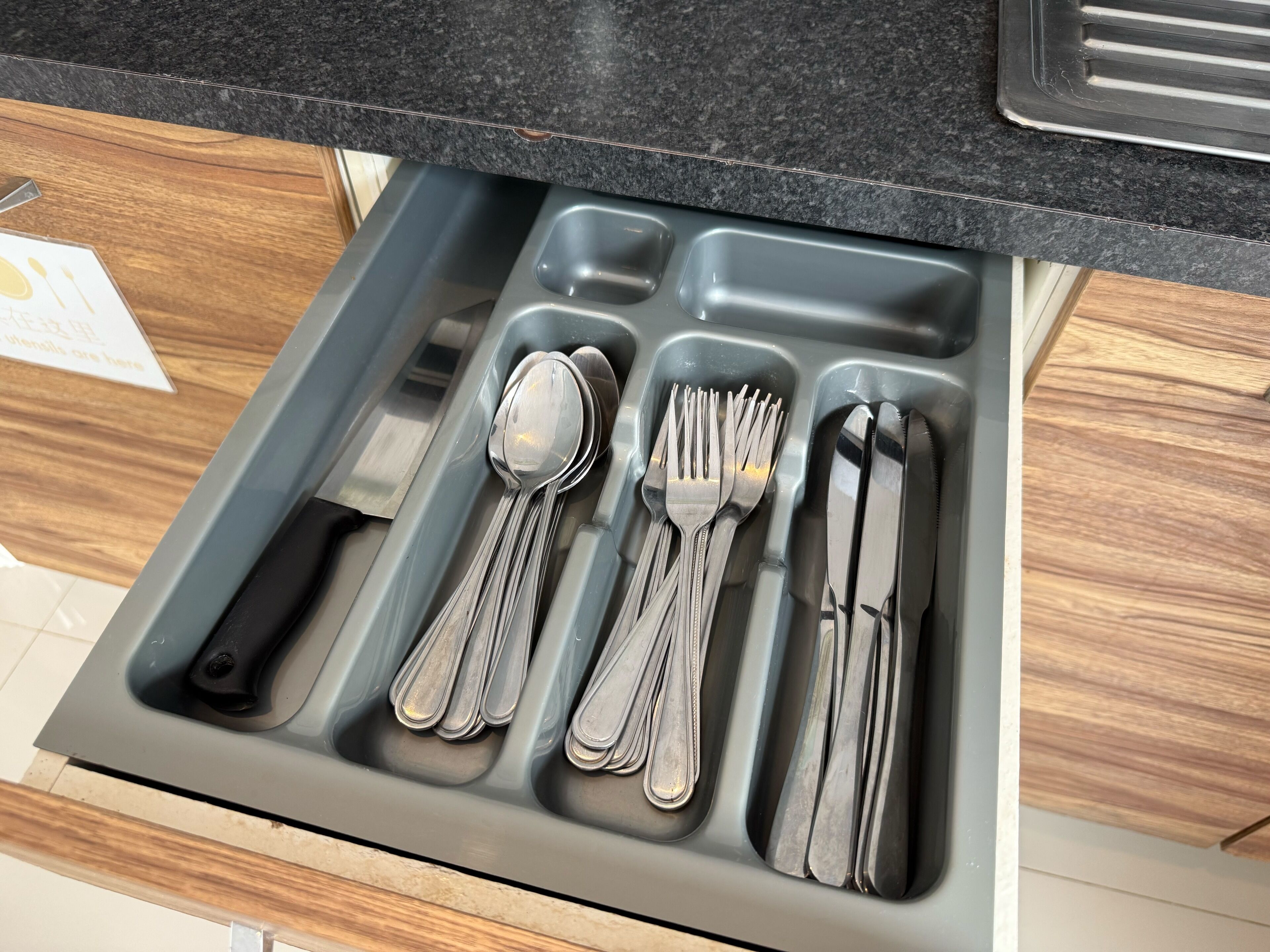 A kitchen drawer with utensils neatly organized.