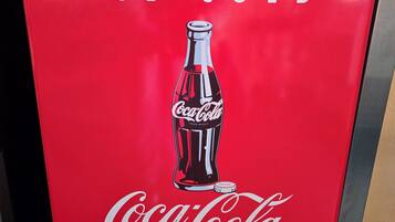A red Coca-Cola branded ice cold beverage bag.