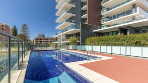 Un immeuble d’appartements moderne doté d’une piscine sur le toit.