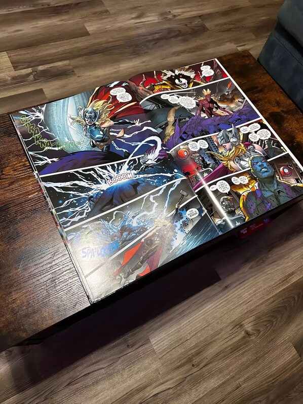 A wooden table with a comic book-style puzzle featuring a space battle scene.
