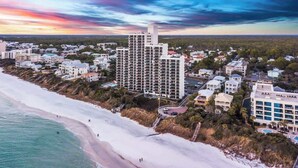 A coastal town with a prominent high-rise hotel, beachfront properties, and a mix of residential buildings. - One Seagrove Place 0406 (Santa Rosa Beach)