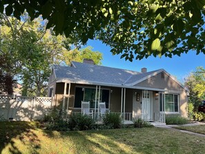 A single-story house with a front porch, a covered entryway, and a garage.