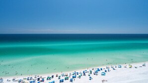 A beach with clear turquoise water and a sandy shore. - One Seagrove Place 1503 (Santa Rosa Beach)