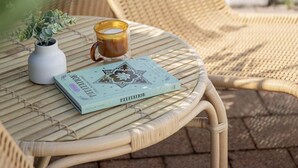 A wicker chair and table with a book and a cup on it. - Palm Springs Oasis, short walk to Shelly Beach (Bateau Bay)