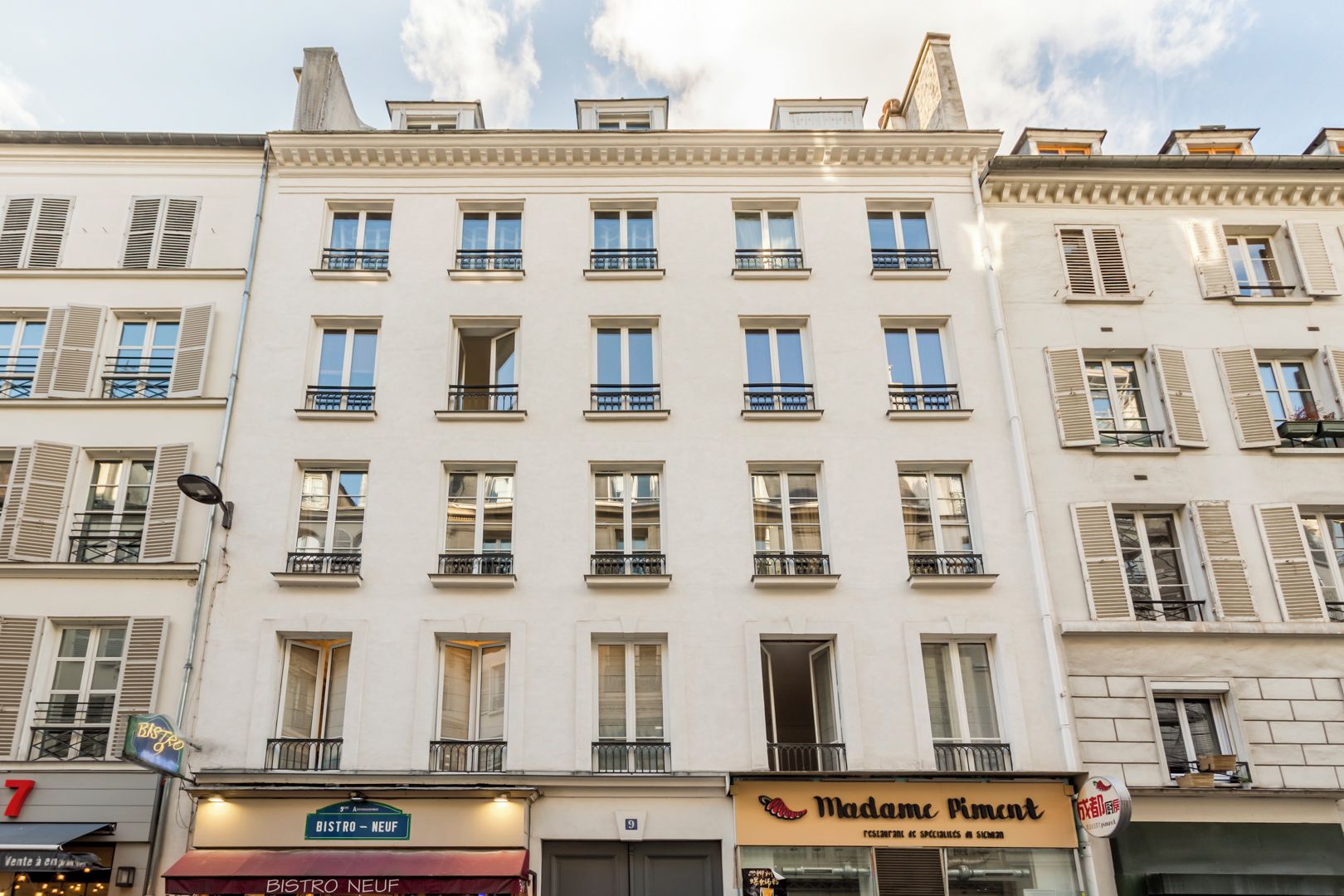 A multi-story building with a restaurant named 'Madame Pincourt' on the ground floor.