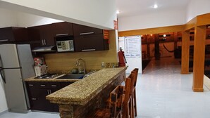A kitchen with a granite countertop, stainless steel appliances, and a built-in oven.
