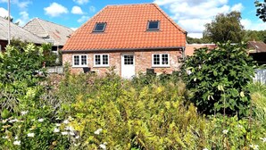 A two-story house with a red-tiled roof, brick walls, and a small window on the second floor. - "Arnora" - 48km from the sea by Interhome (Højer)