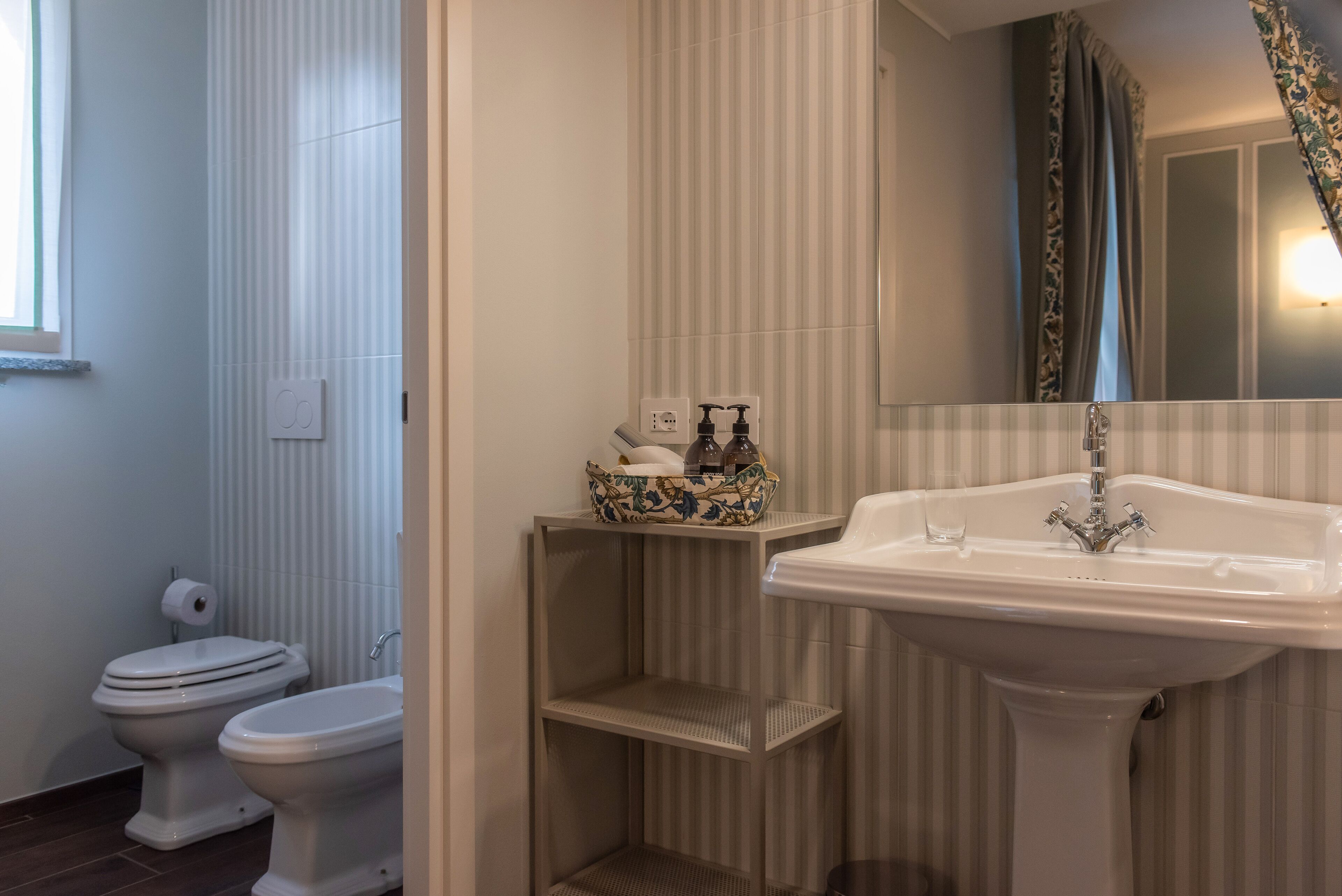 A bathroom with a toilet, a sink, and a shower curtain.