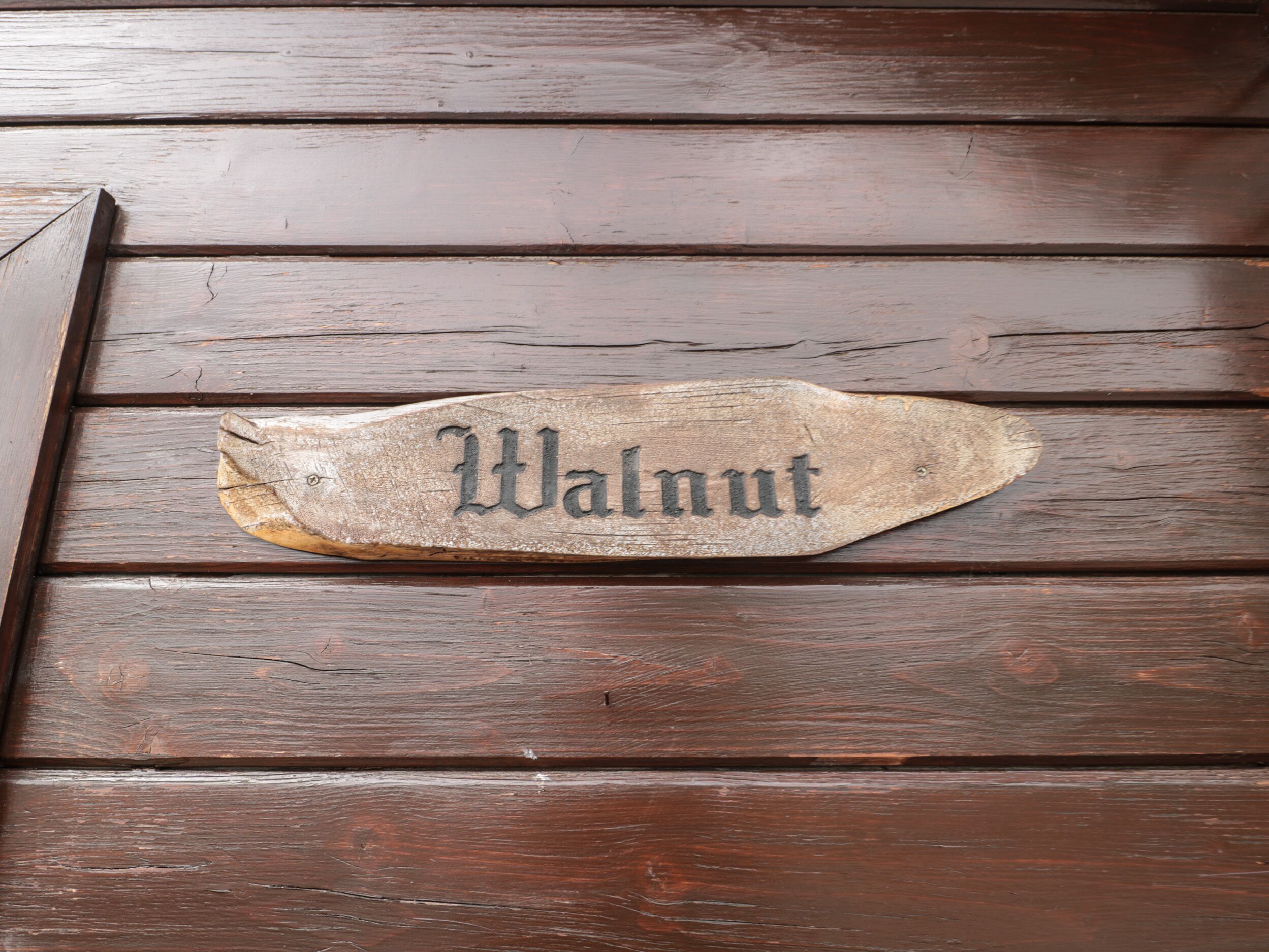 Un cartello di legno con la scritta 'Walnut' incisa.