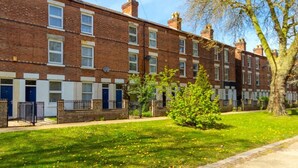 A row of terraced houses with brick facades, front gardens, and a clear sky. - Waterloo House – Contractors, Families, Holidays (Nottingham)