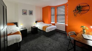A hotel room with two beds, a desk, and a chair. - St Michael`s House Contractors, Families, Groups (Nottingham)