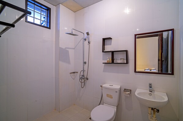 A bathroom with a shower, toilet, sink, and a mirror. - Hoi An Viet House Homestay (Da Nang)