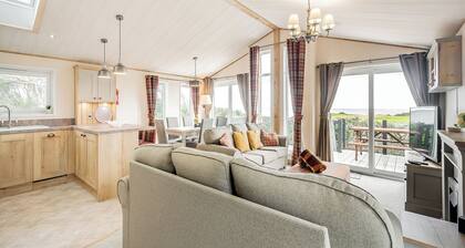 Country and modern cladded lodge with sea views.