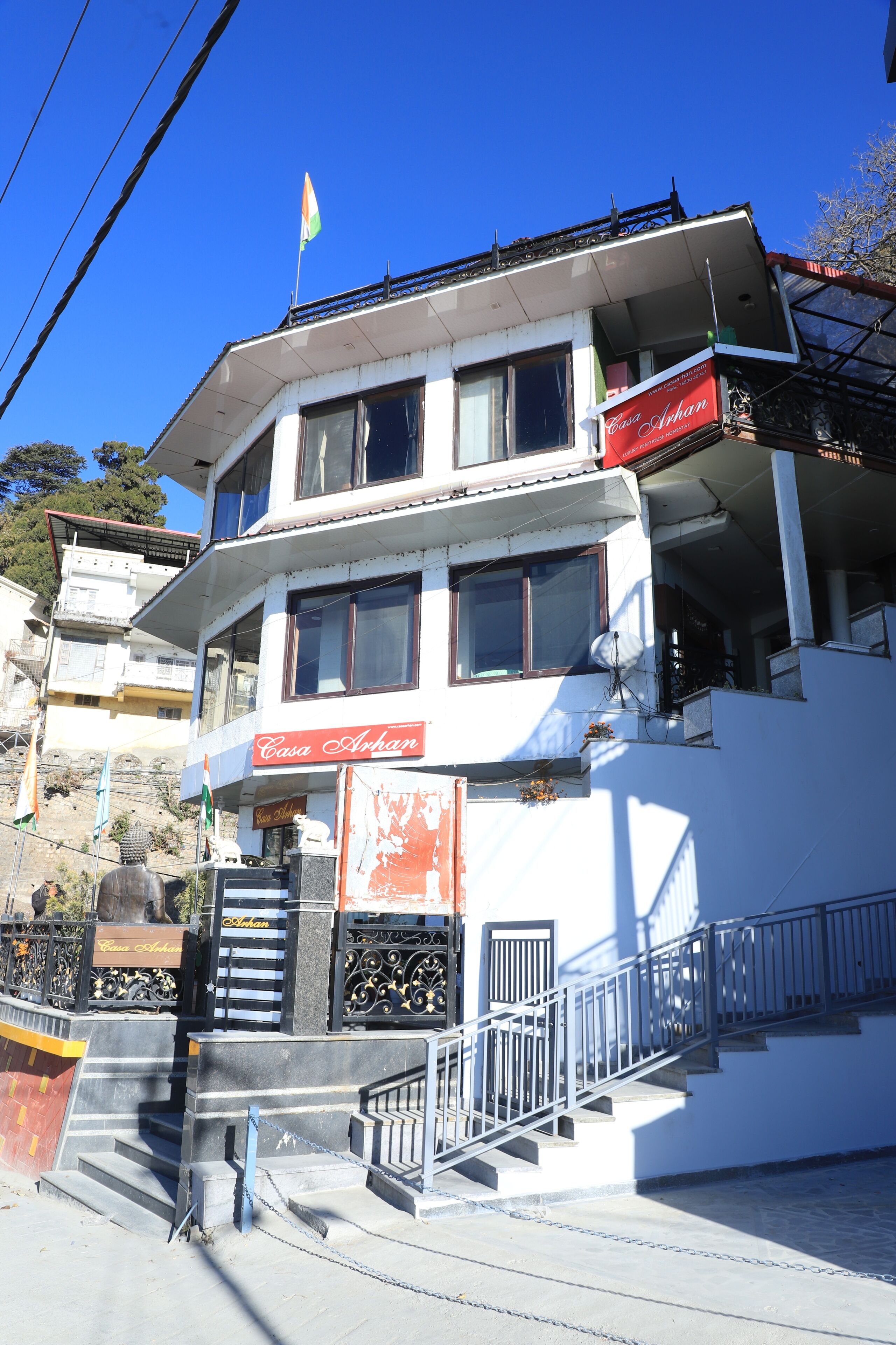 A multi-story building with a sign reading 'Casa Afghan' and a flag on top.