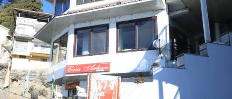 A multi-story building with a sign reading 'Casa Afghan' and a flag on top.