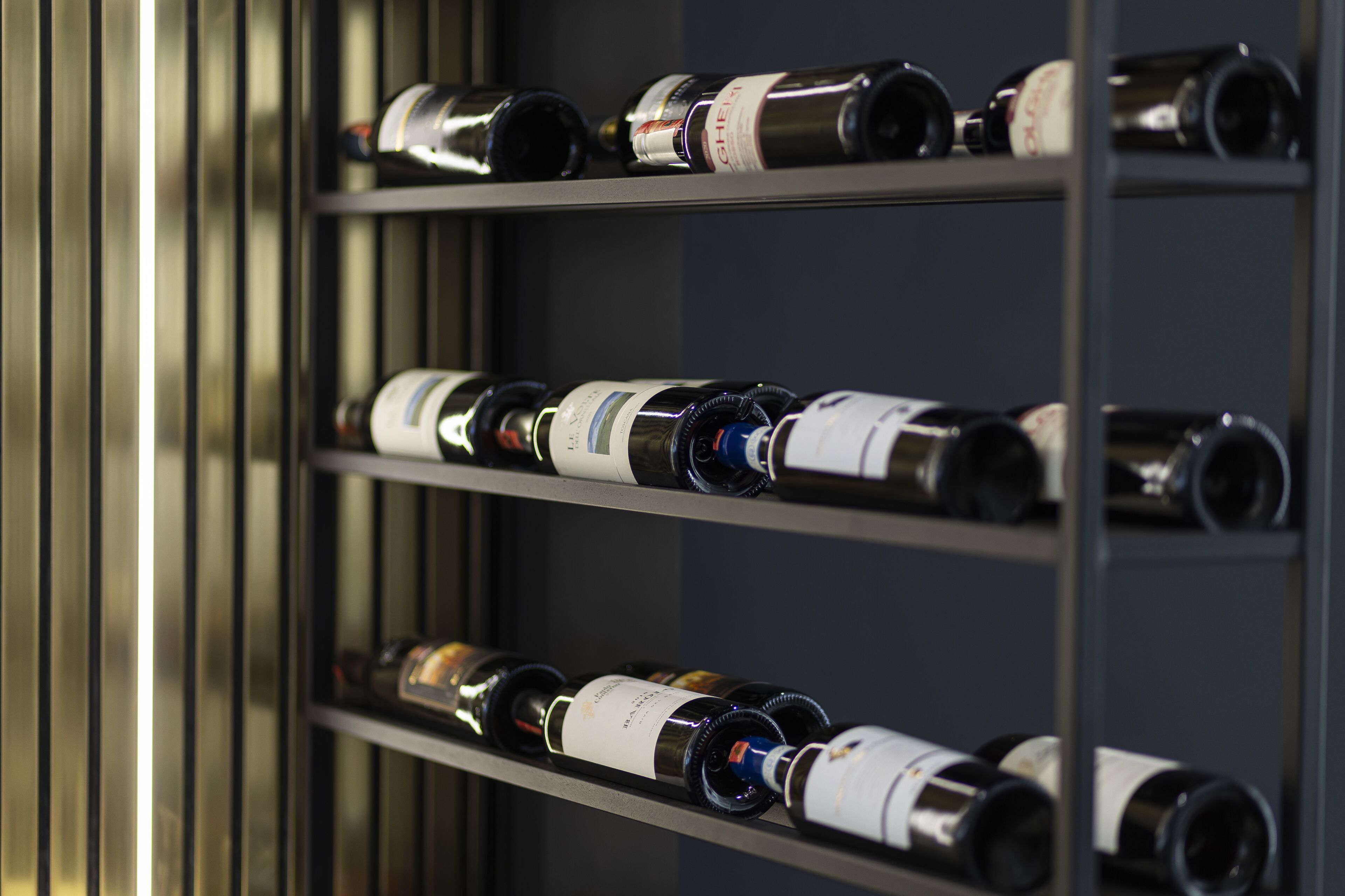 A wine rack with multiple bottles of wine.