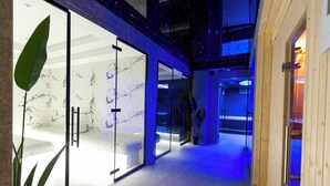A modern interior with a glass wall, a plant, and a wooden door. - Destiny Hotel (Kashar)