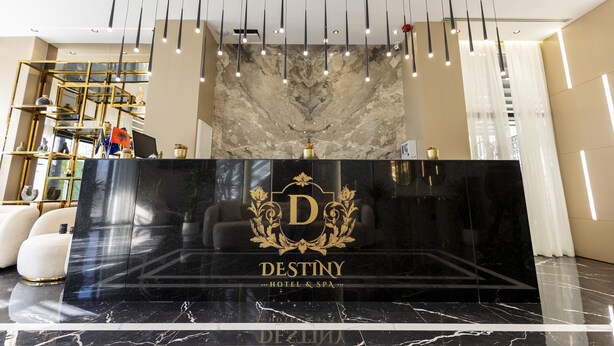 A reception desk with a marble top and a logo that reads "DESTINY HOTEL & SPA". - Destiny Hotel (Kashar)