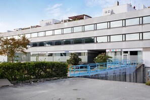 A modern building with a flat facade, large windows, and a blue staircase leading to an entrance. - Apartment 'Attico Con Terrazza A Viareggio' with Mountain View, Shared Terrace and Air Conditioning (Viareggio)