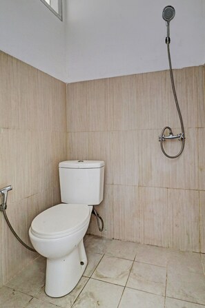 Bathroom features a shower unit and toilet, with a window offering natural ventilation.