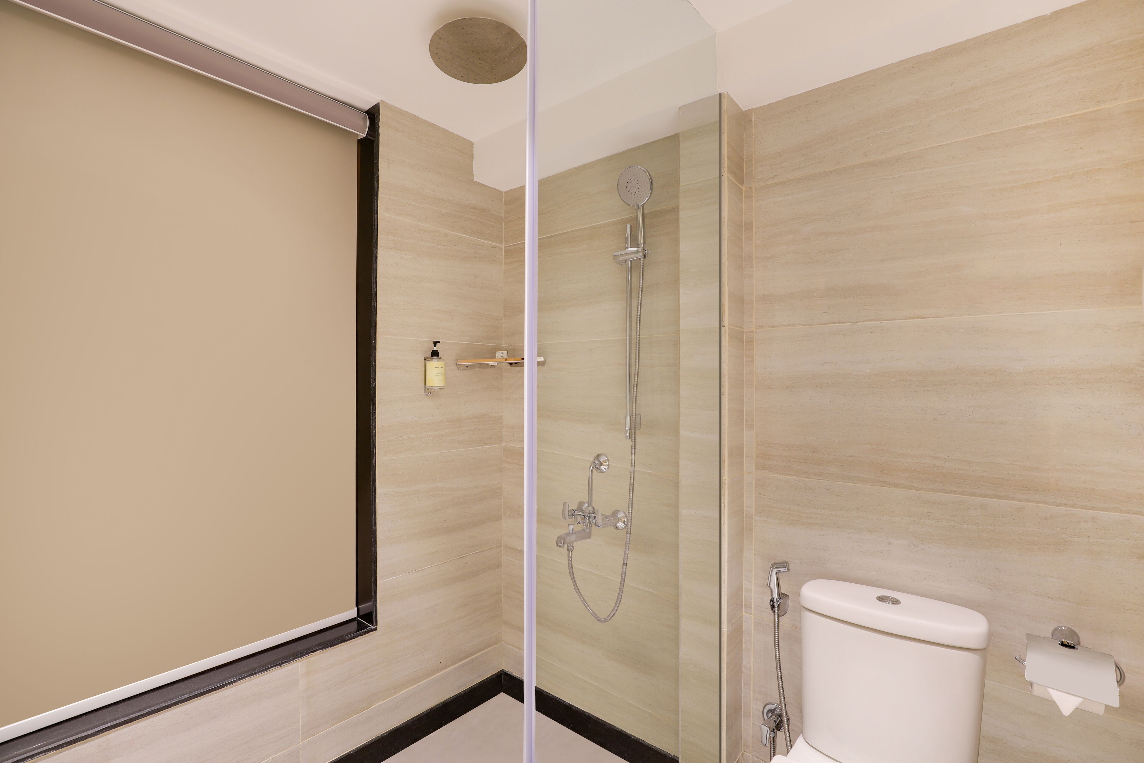 A modern bathroom with a shower, toilet, and a towel rack.