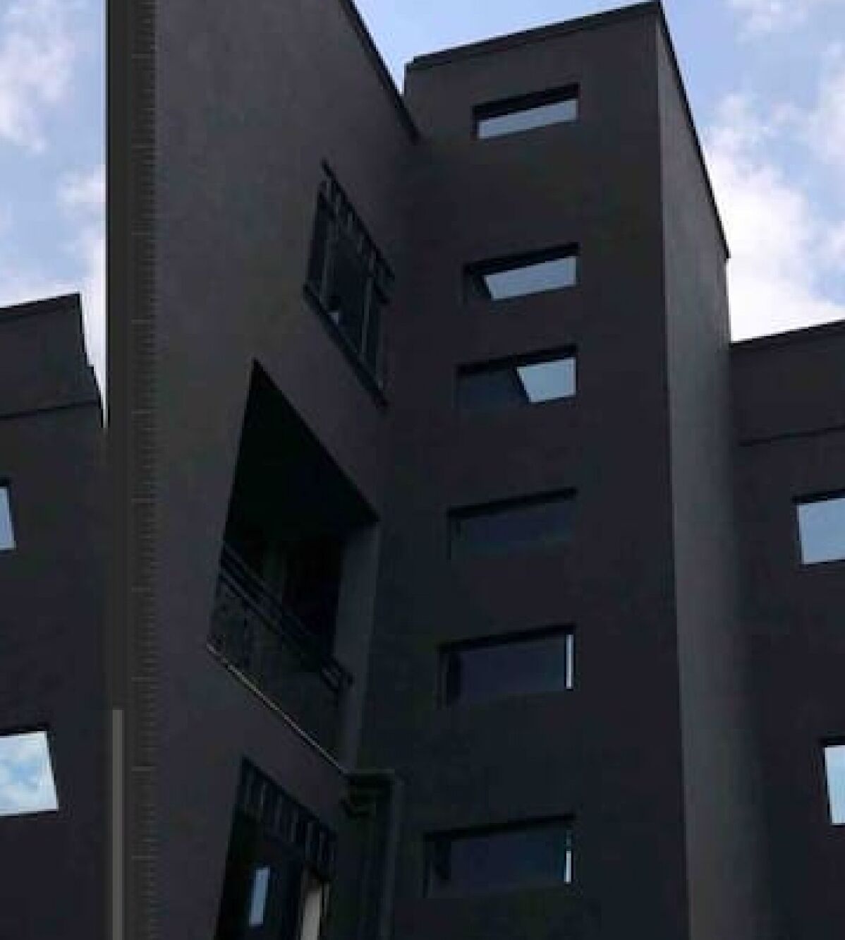 A modern building with a flat roof, multiple windows, and a balcony.