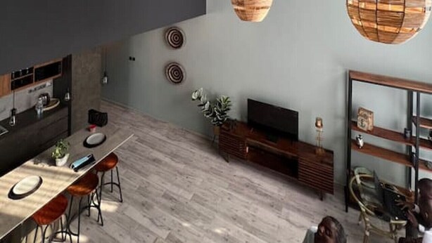Una cocina moderna con comedor, lámparas colgantes de madera y un amplio ventanal.