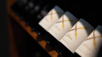 A row of wine bottles with labels, each featuring a gold cross design.