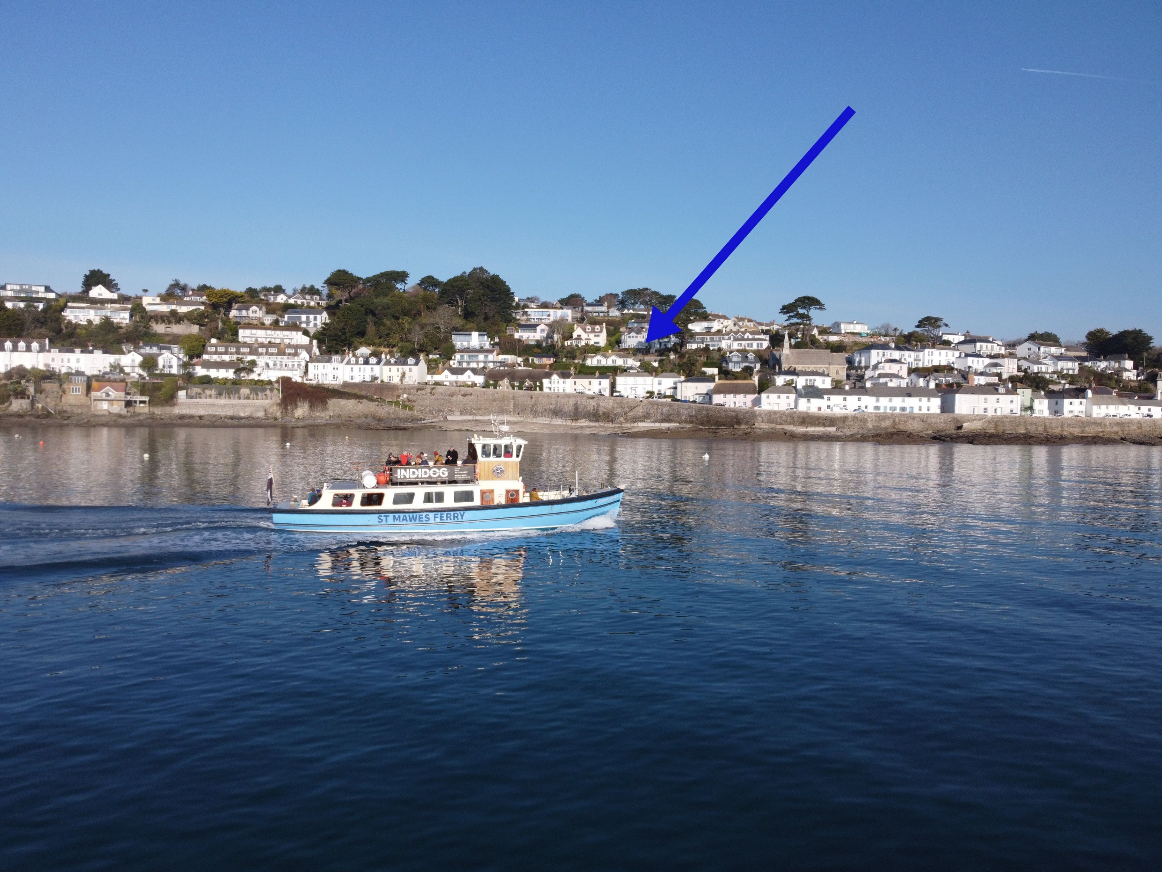A ferry with "ST MAWES FERRY" written on the side, sailing on calm waters.