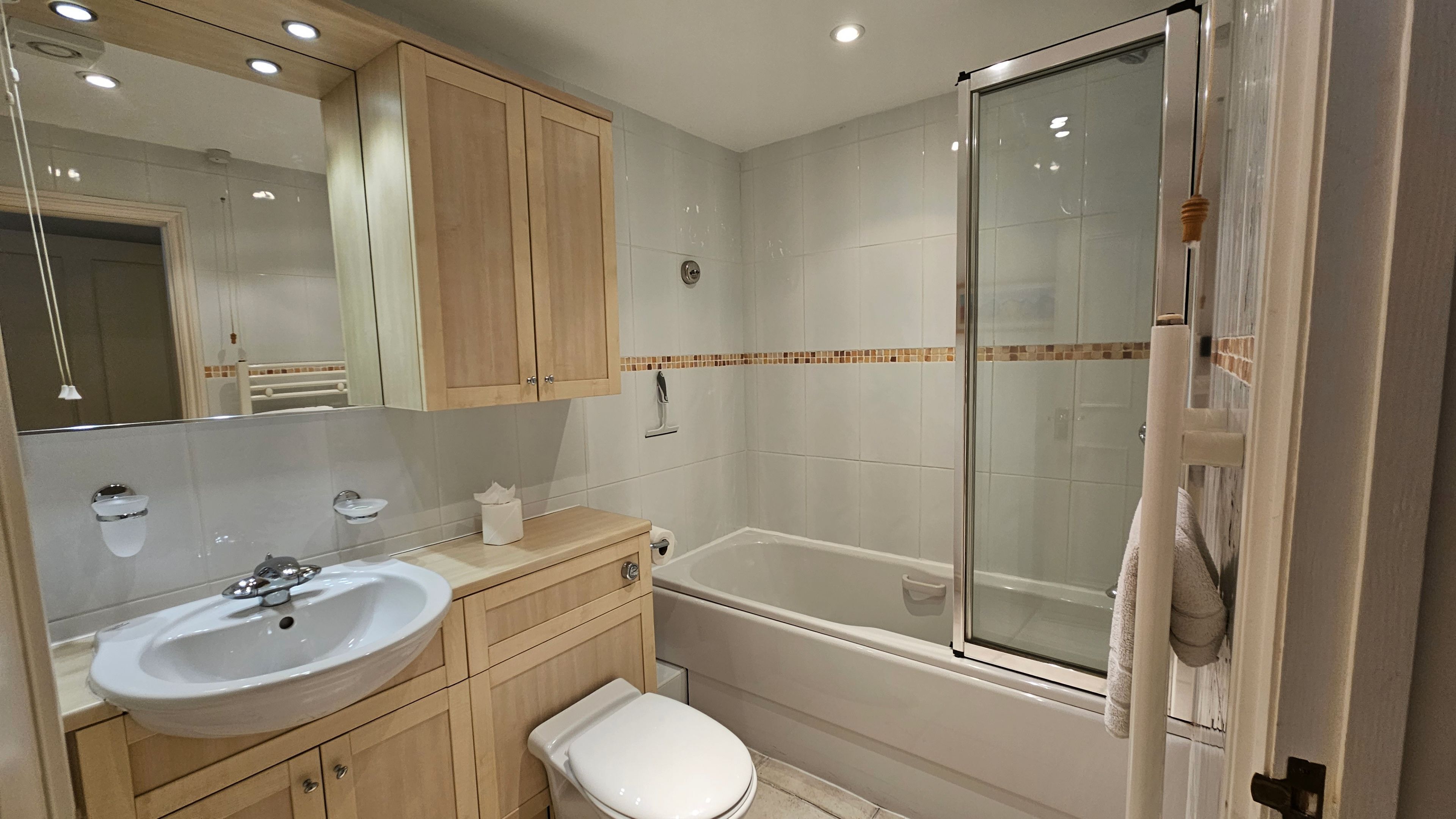 A bathroom with a sink, toilet, and bathtub.