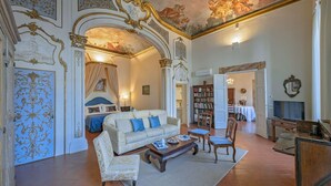 A luxurious room with a large bed, a sofa, a coffee table, and a dining area. - Apartment in Florence with 3 bedrooms sleeps 5 (Florence)