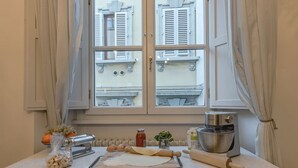 A kitchen counter with a rolling pin, a rolling board, a pasta machine, a bowl, and a bottle of sauce. - Apartment in Florence with 3 bedrooms sleeps 5 (Florence)
