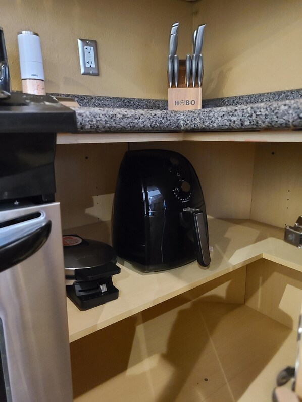 A kitchen with a coffee maker, a toaster, and a knife block on the countertop. - Cozy and Charming Vacation Rental Near Downtown Fargo (Fargo)