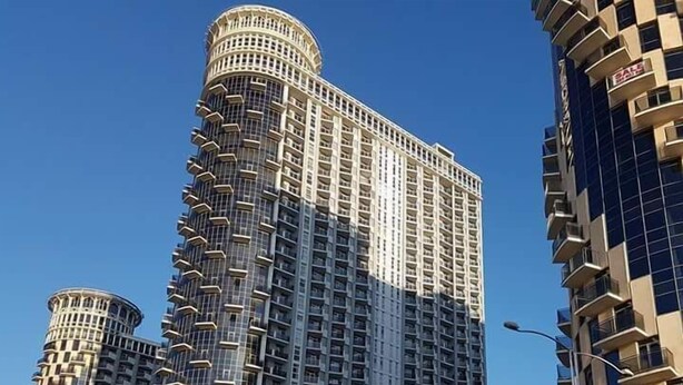 A high-rise building with multiple balconies and a cylindrical section at the top. - Orbi Sea Towers Batumi (Batumi)
