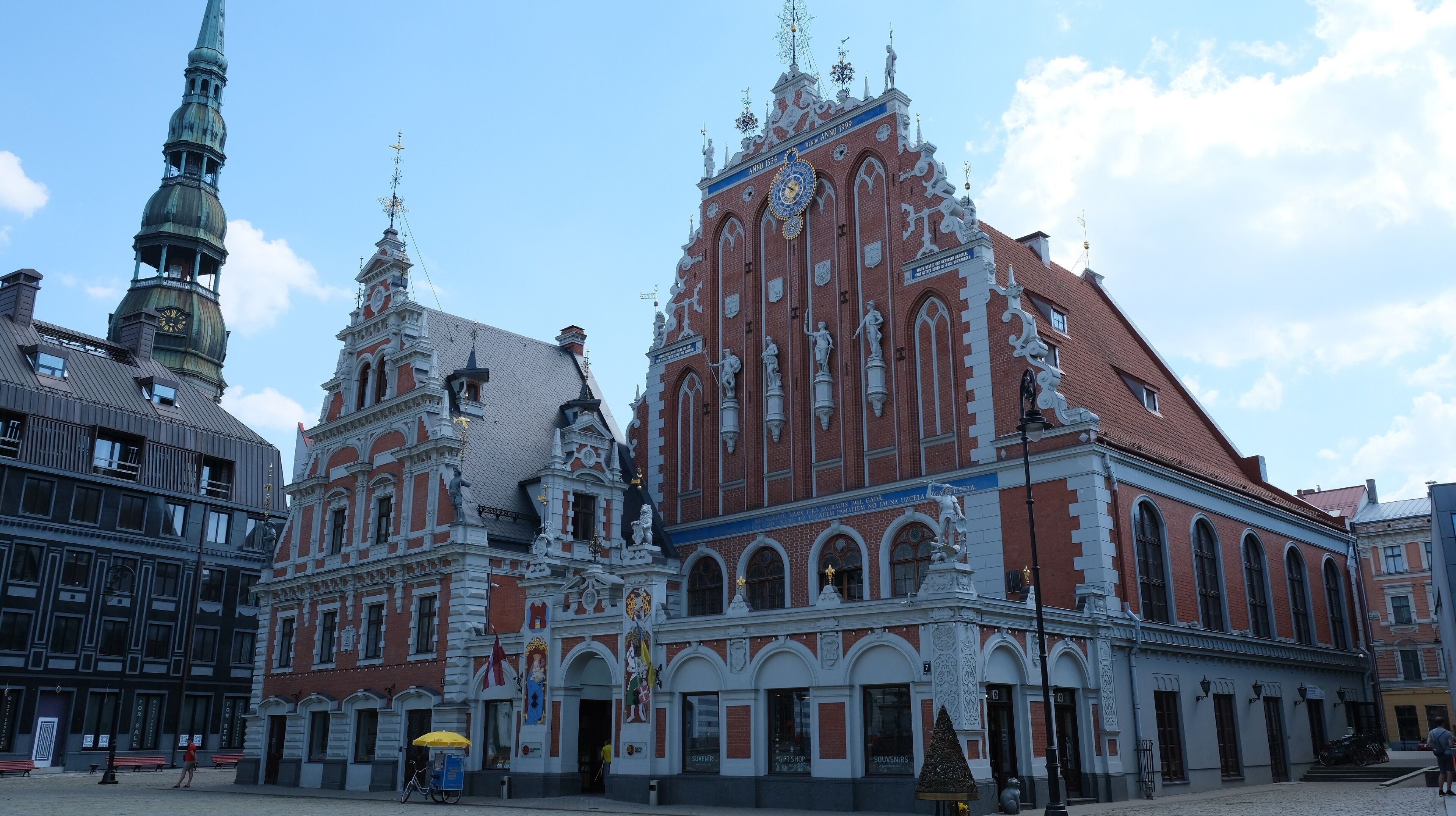 A historic building with ornate architecture, including statues and a clock tower.