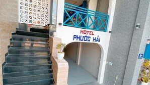 A staircase leading to a hotel entrance with a sign reading "HOTEL PHUOC HAI". - Phuoc Hai Hotel By The Moment (Ho Chi Minh City)