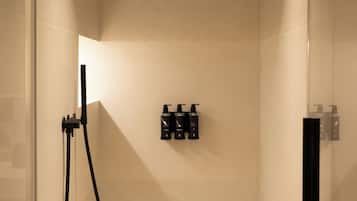 A modern shower with a handheld showerhead and a wall-mounted control panel.