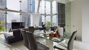 A modern dining area with a glass table, black chairs, and a city view. - Amazing Skyline Views 3BR Duplex (Manchester)
