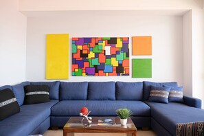 Plush sofa and colorful artwork make a great combination - Soho PV: Luxury, Art, and Breathtaking Views (Puerto Vallarta)