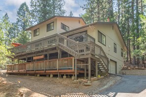A two-story house with a balcony and a covered porch area.