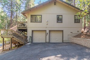 A two-story house with a covered porch and a garage.