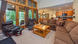 A spacious living room with a sectional sofa, a recliner, and a wooden coffee table. - Family Ski Retreat w/ Hot Tub & Views (McHenry)