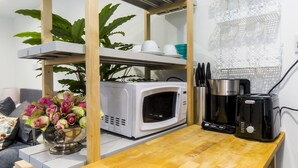 A compact kitchen with a microwave, toaster, and coffee maker on a wooden countertop. - Cozy Brixton Hideaway – Cute & Convenient Stay - Pass the Keys (London)