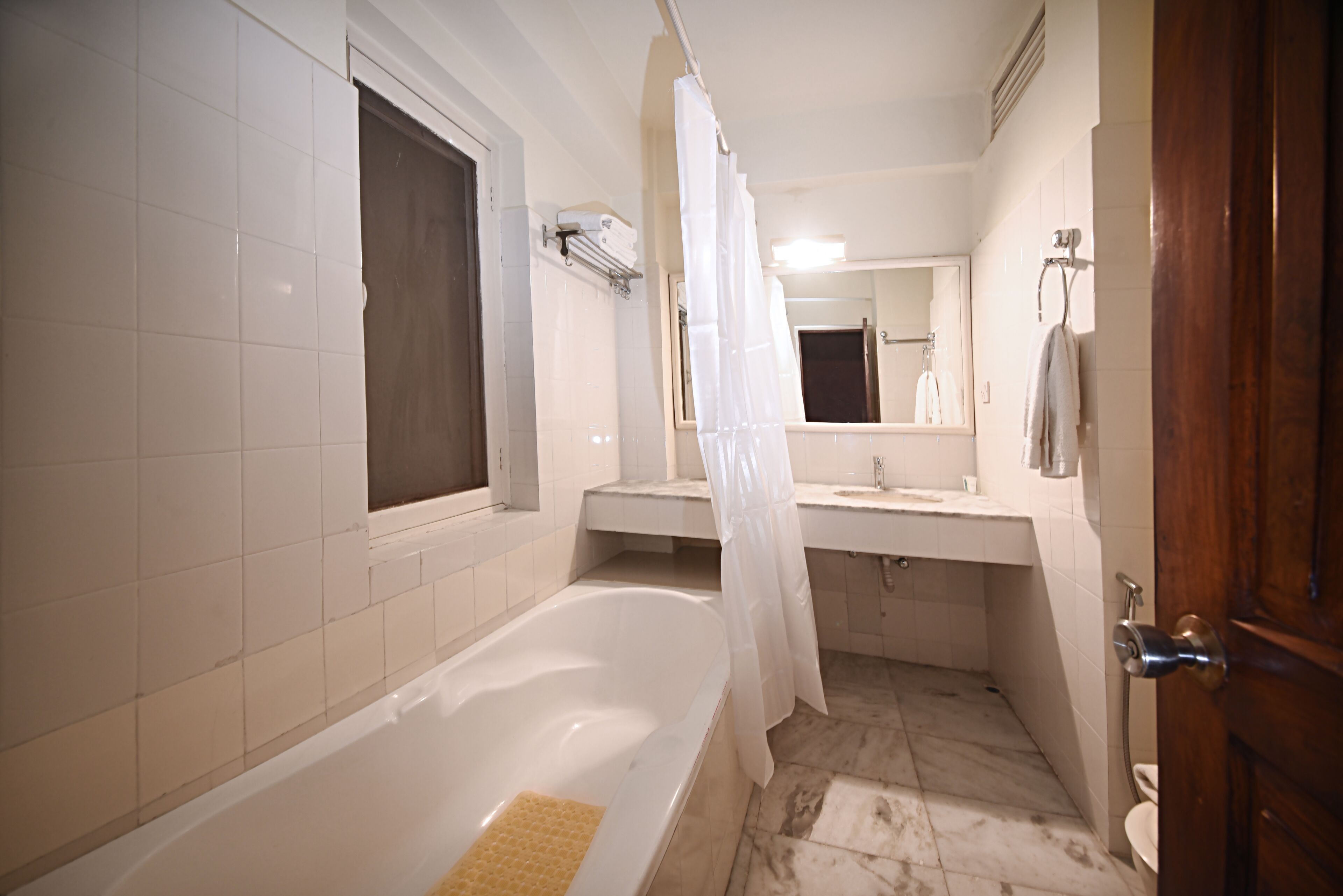 A bathroom with a bathtub, a shower, a sink, and a toilet.