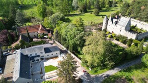 An aerial view of a castle with a large courtyard, surrounded by lush greenery and a well-maintained garden. - Gite La Loire 4/5 Personnes à la Campagne Prés des Vergers (Lignières-de-Touraine)