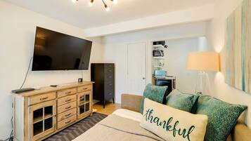 Laptop workspace, iron/ironing board, bed sheets