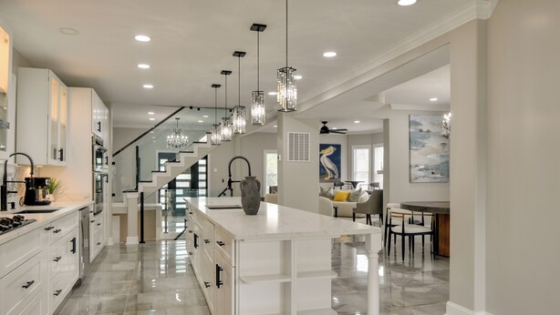 A modern kitchen with white cabinetry, a marble countertop island, and pendant lighting. - 5 Mi to Inner Harbor: Expansive Family Getaway (Baltimore)